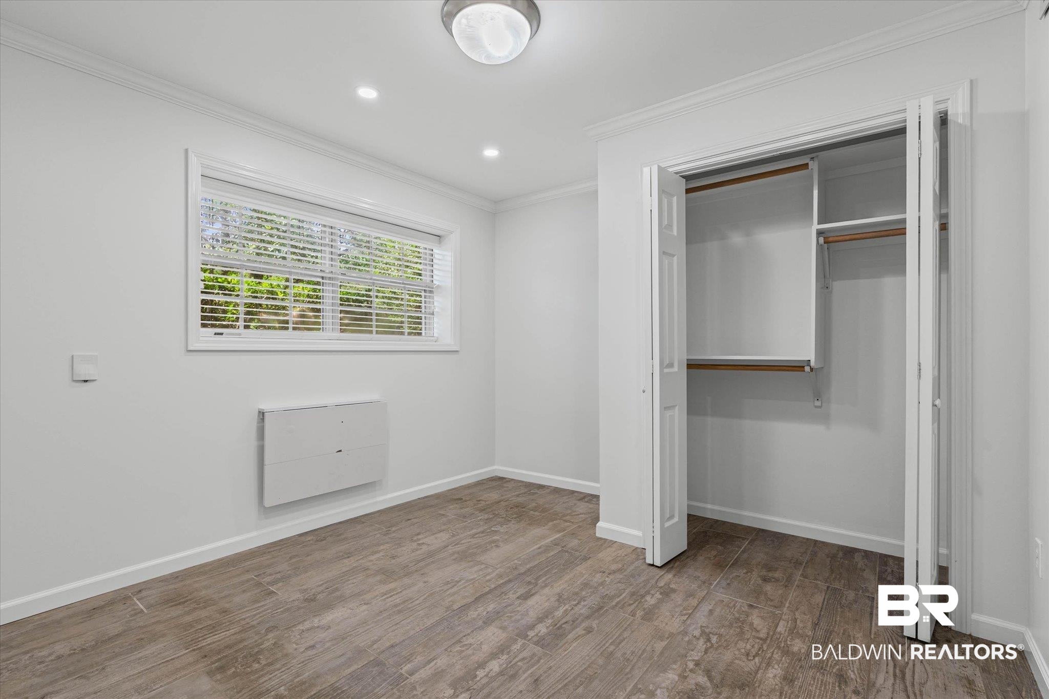 8301 Fordham Road Mobile, AL 36619 - Photo 24 of 57 Bright room featuring wood-finish flooring and a window with horizontal blinds