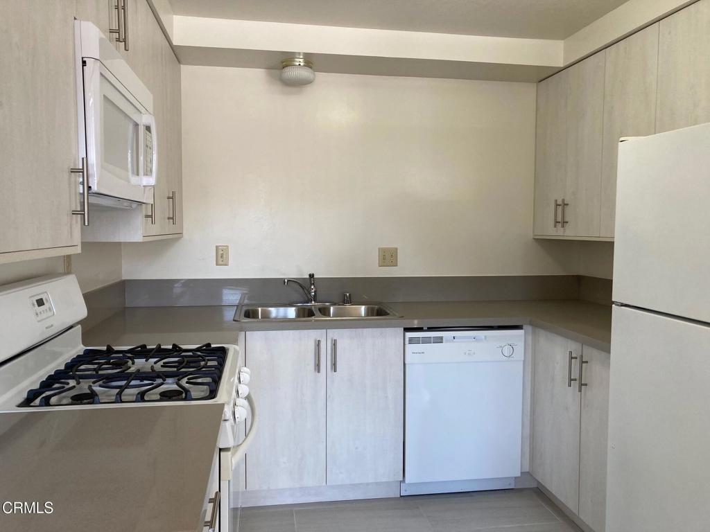 22 North 5th Street, Unit 4 Alhambra, CA 91801 - Photo 2 of 6 a kitchen with granite countertop a sink stove and cabinets