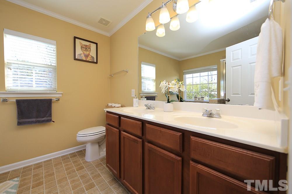 800 Roni Court Cary, NC 27519 - Photo 16 of 25 a bathroom with a sink a toilet and a mirror