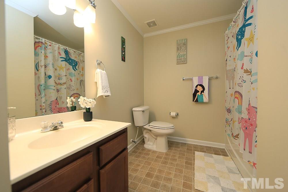 800 Roni Court Cary, NC 27519 - Photo 19 of 25 a bathroom with a sink and a mirror