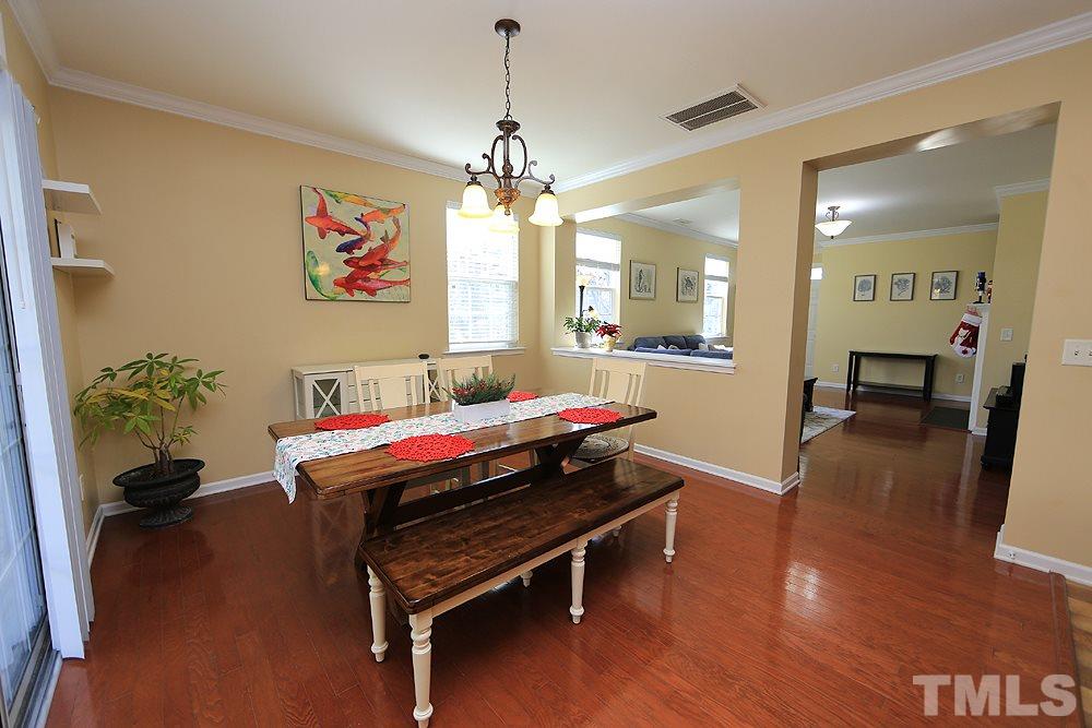 800 Roni Court Cary, NC 27519 - Photo 7 of 25 a living room with furniture and a chandelier