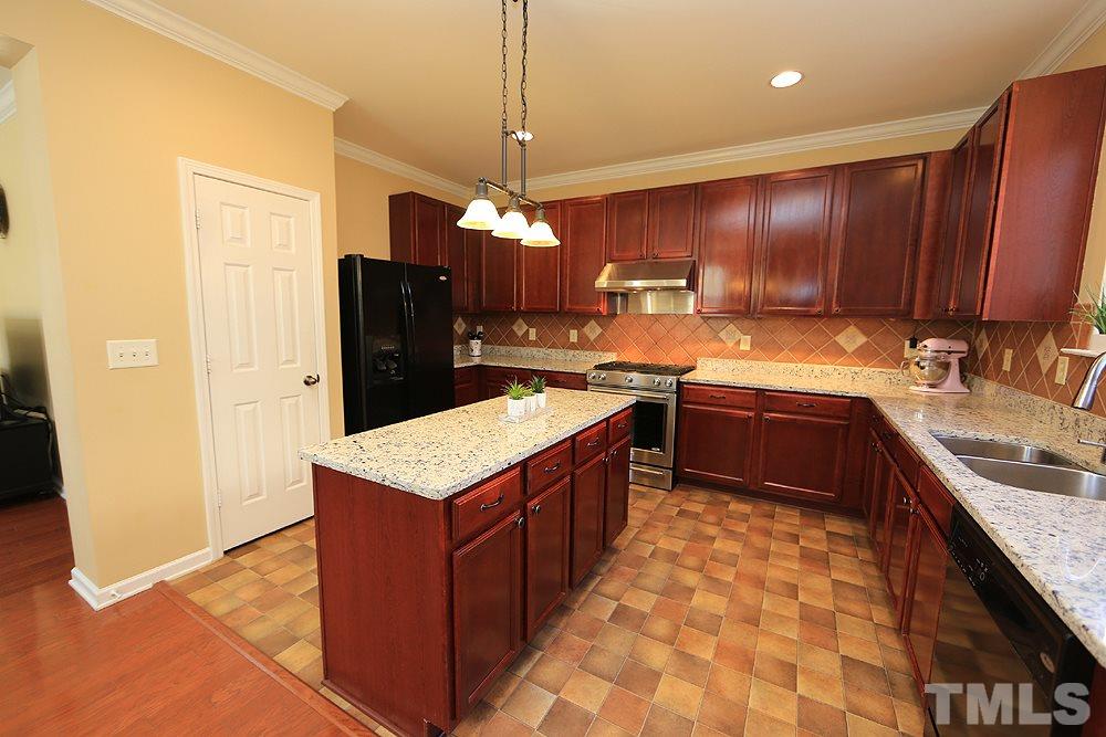 800 Roni Court Cary, NC 27519 - Photo 8 of 25 a kitchen with stainless steel appliances granite countertop a sink stove and refrigerator