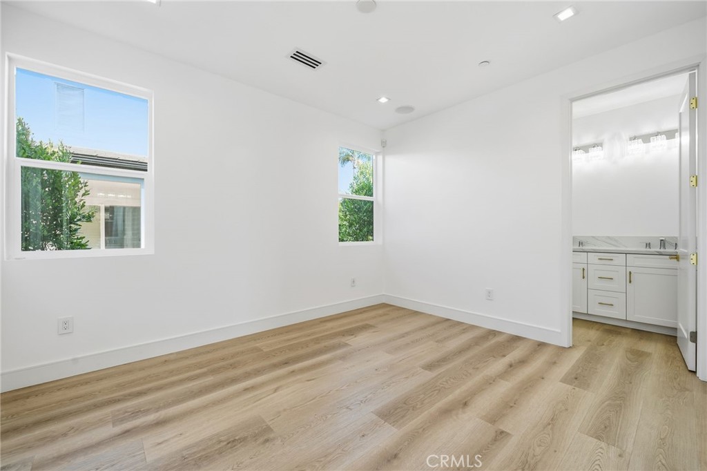 317 Rochester Street, Unit B Costa Mesa, CA 92627 - Photo 6 of 12 wooden floor in an empty room with a window