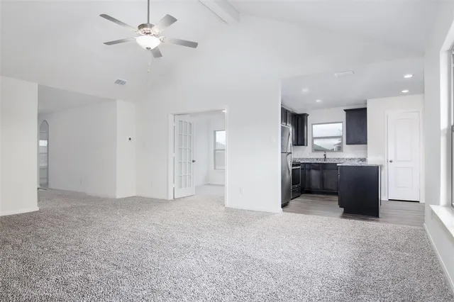 a view of kitchen with refrigerator and a sink
