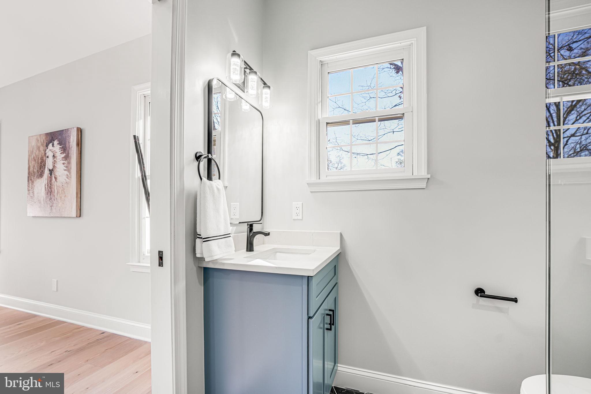 3620 Hill Street Fairfax, VA 22030 - Photo 11 of 71 a bathroom with a granite countertop sink a mirror a vanity and a shower