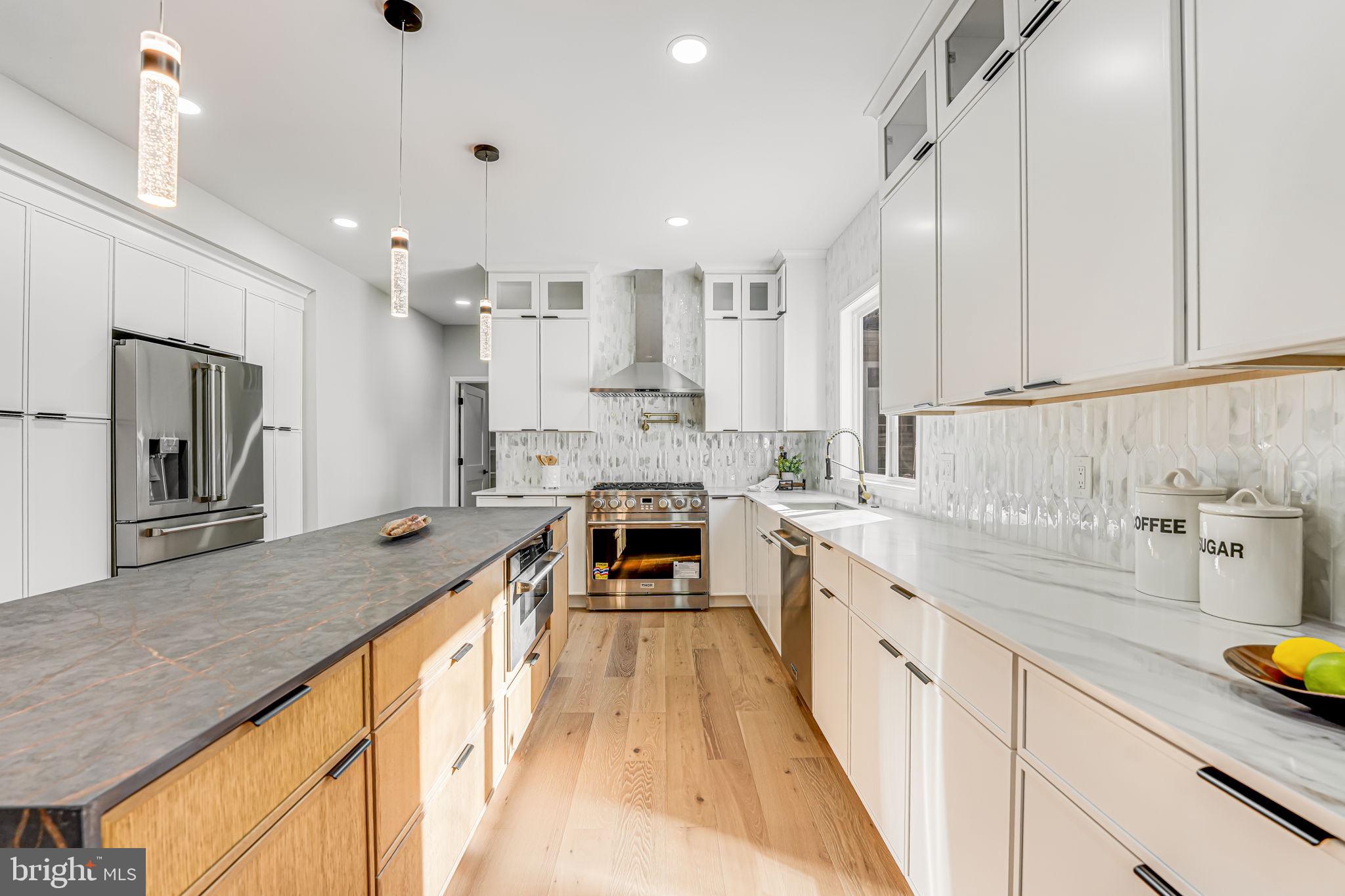 3620 Hill Street Fairfax, VA 22030 - Photo 18 of 71 a large kitchen with kitchen island a large counter space a sink appliances and cabinets