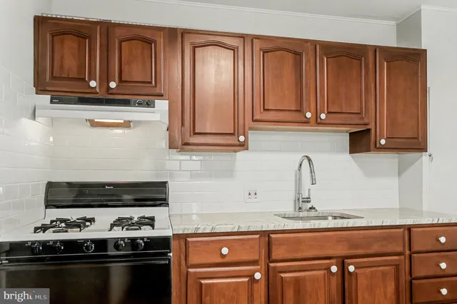 a kitchen with granite countertop cabinets and stainless steel appliances