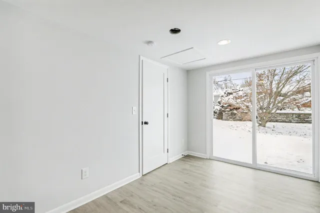 a view of a livingroom with wooden floor and a window