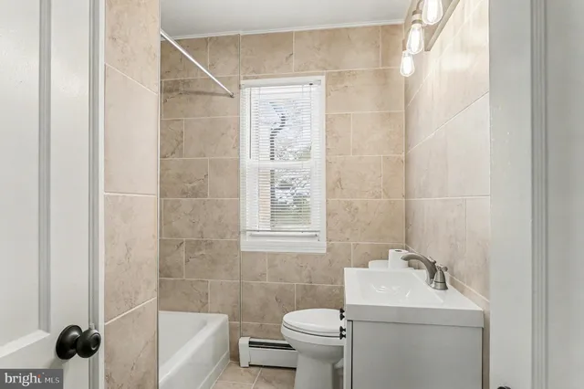 a bathroom with a sink mirror toilet and shower