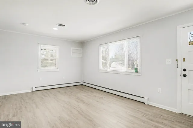 wooden floor in an empty room with a window