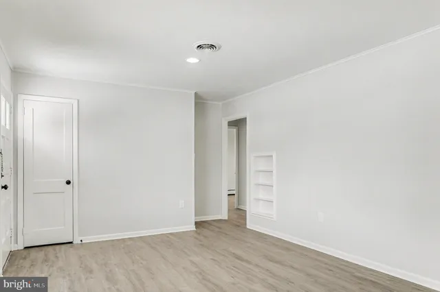 an empty room with wooden floor