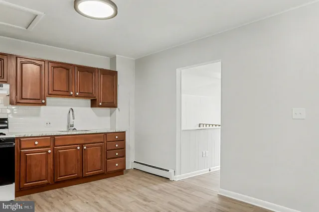 a kitchen with stainless steel appliances granite countertop a sink and wooden cabinets