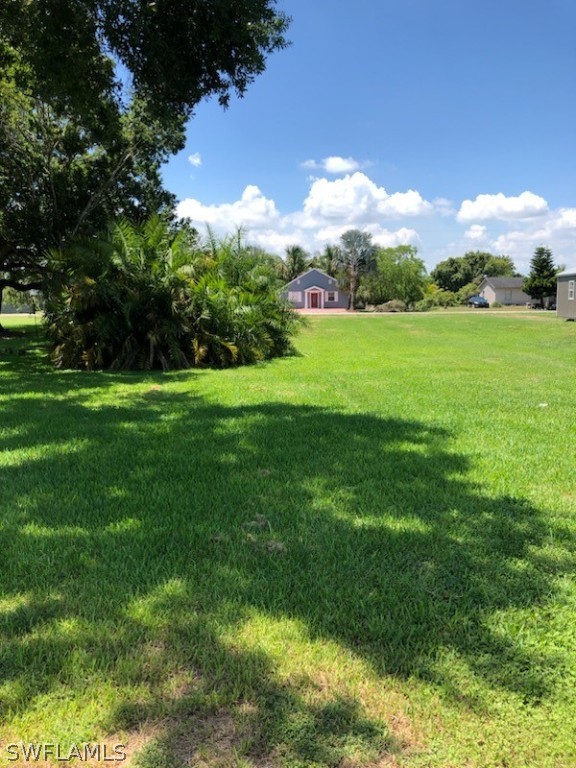 464 Avenue R Moore Haven, FL 33471 - Photo 2 of 3 a view of building with garden and trees