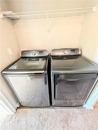 a bathroom with a double vanity sink toilet and shower