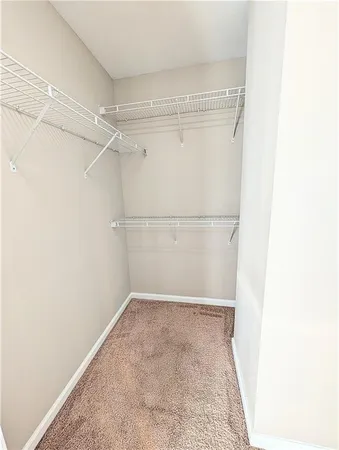 a spacious bathroom with a sink a toilet and a mirror