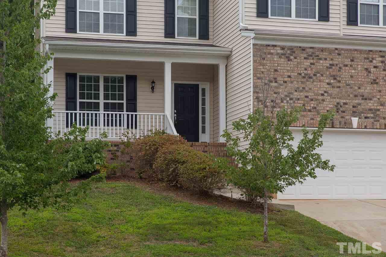 707 Turmeric Lane Durham, NC 27713 - Photo 2 of 18 a front view of a house with garden