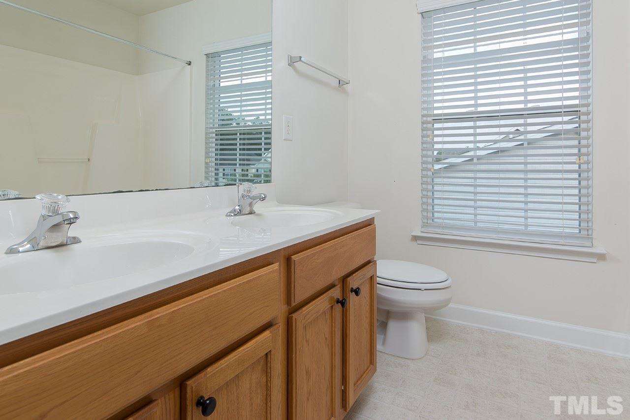 707 Turmeric Lane Durham, NC 27713 - Photo 13 of 18 a bathroom with a sink a toilet and a window