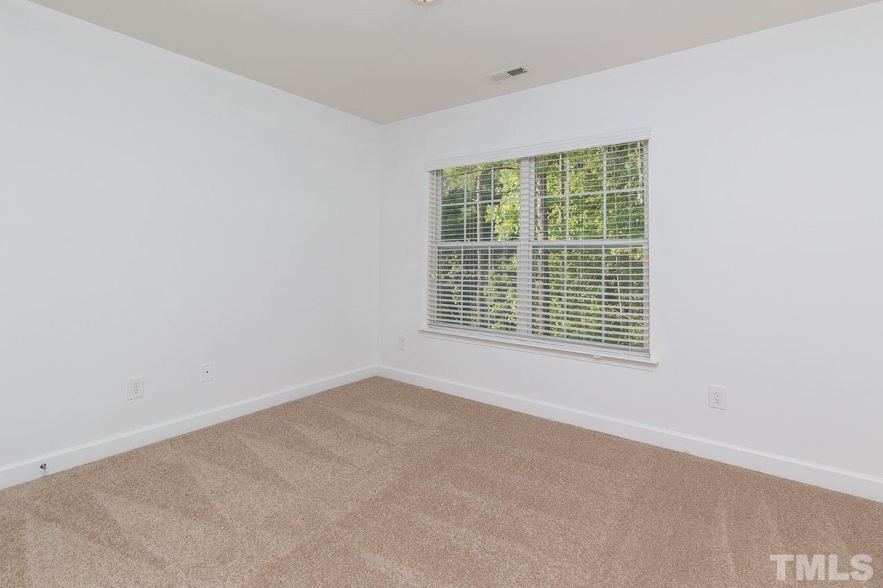 707 Turmeric Lane Durham, NC 27713 - Photo 15 of 18 a view of an empty room with a window