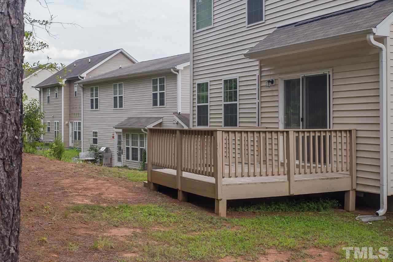 707 Turmeric Lane Durham, NC 27713 - Photo 17 of 18 a view of a house with a yard