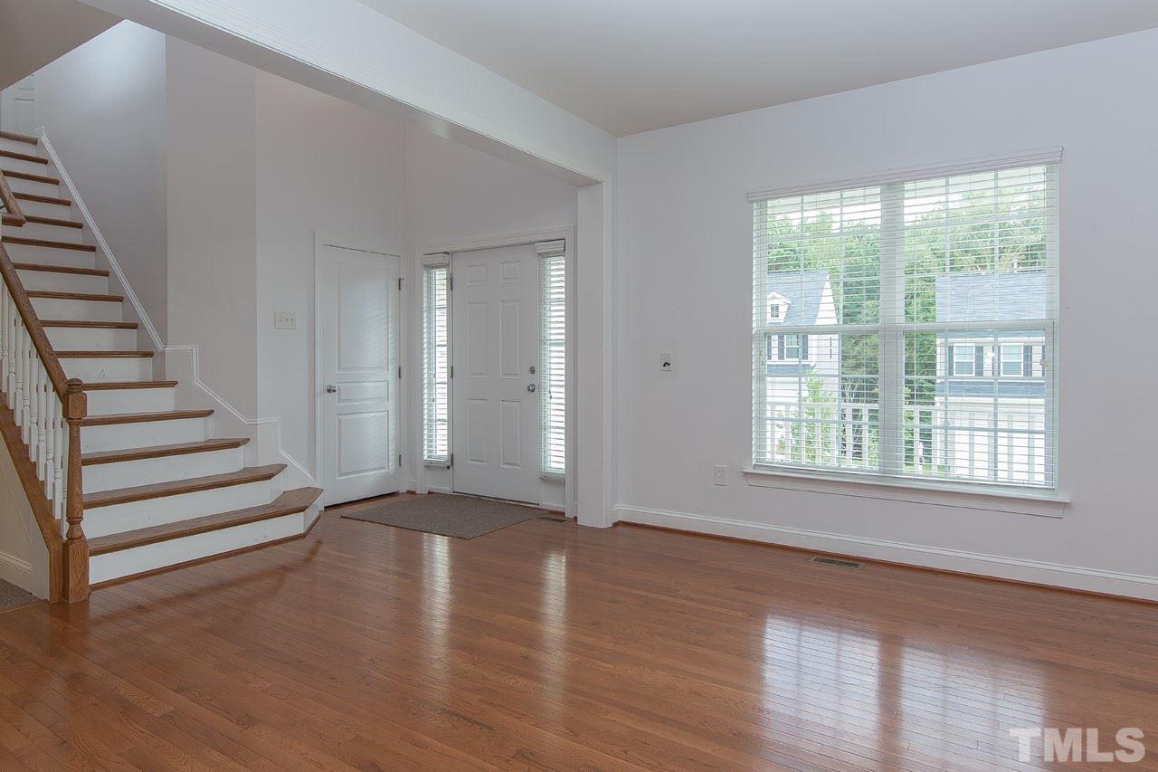 707 Turmeric Lane Durham, NC 27713 - Photo 3 of 18 a view of an empty room with wooden floor and stairs