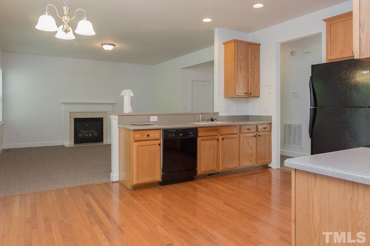 707 Turmeric Lane Durham, NC 27713 - Photo 5 of 18 a view of a kitchen with a sink cabinets and a fireplace