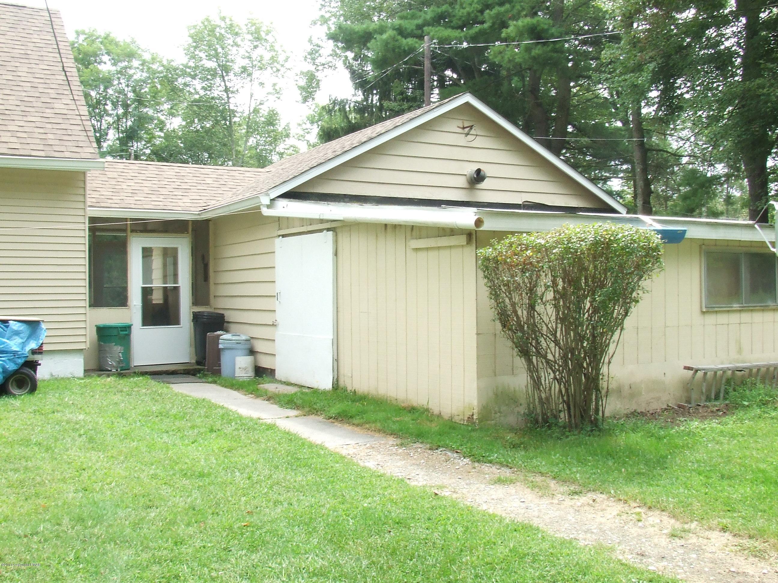 6023 Running Valley Road Stroudsburg, PA 18360 - Photo 20 of 39 a view of a backyard with table and chairs and a large tree