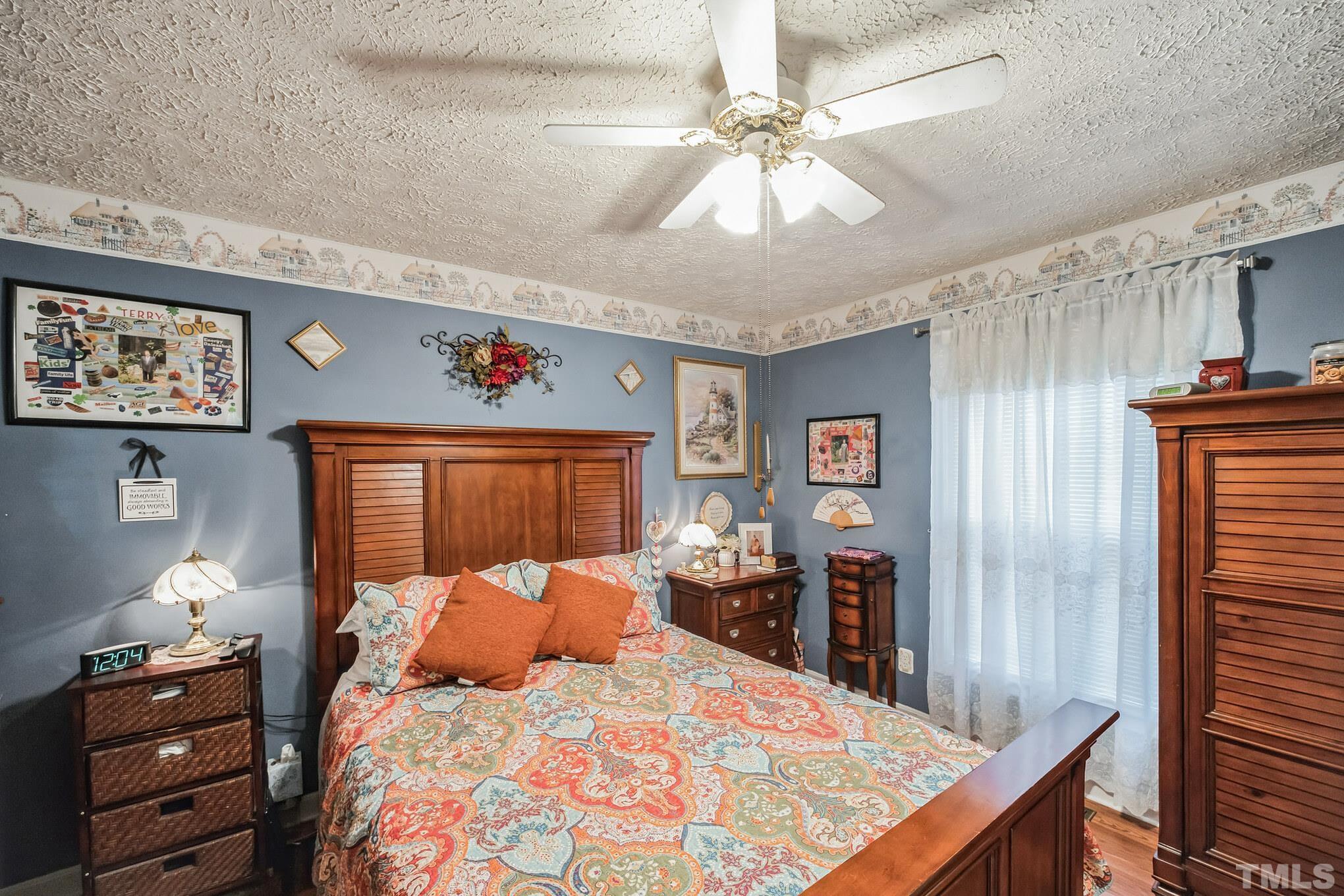 620 Long Avenue Roxboro, NC 27573 - Photo 11 of 39 a bed room with a bed and a chandelier