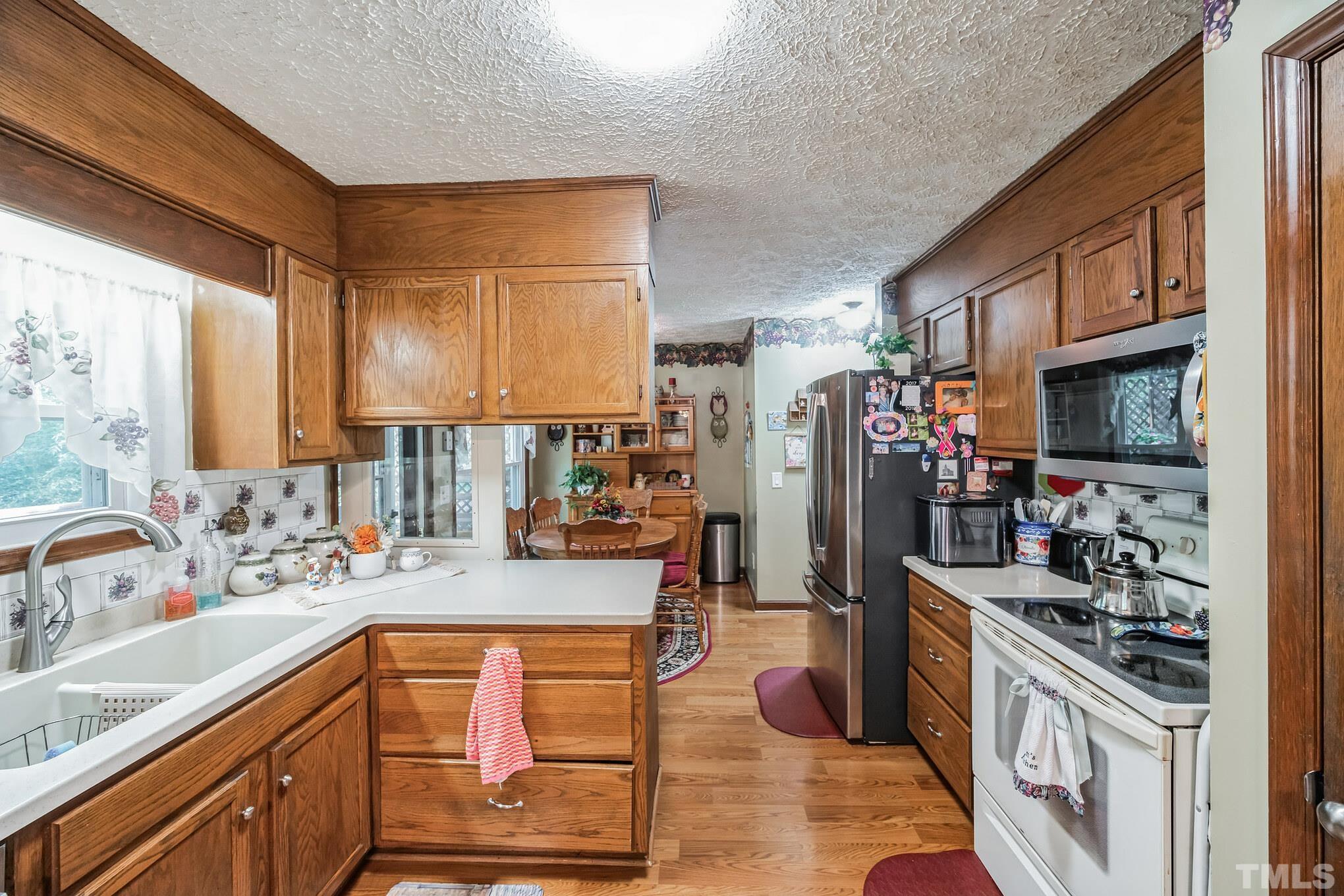 620 Long Avenue Roxboro, NC 27573 - Photo 19 of 39 a kitchen with stainless steel appliances kitchen island granite countertop a sink stove and cabinets