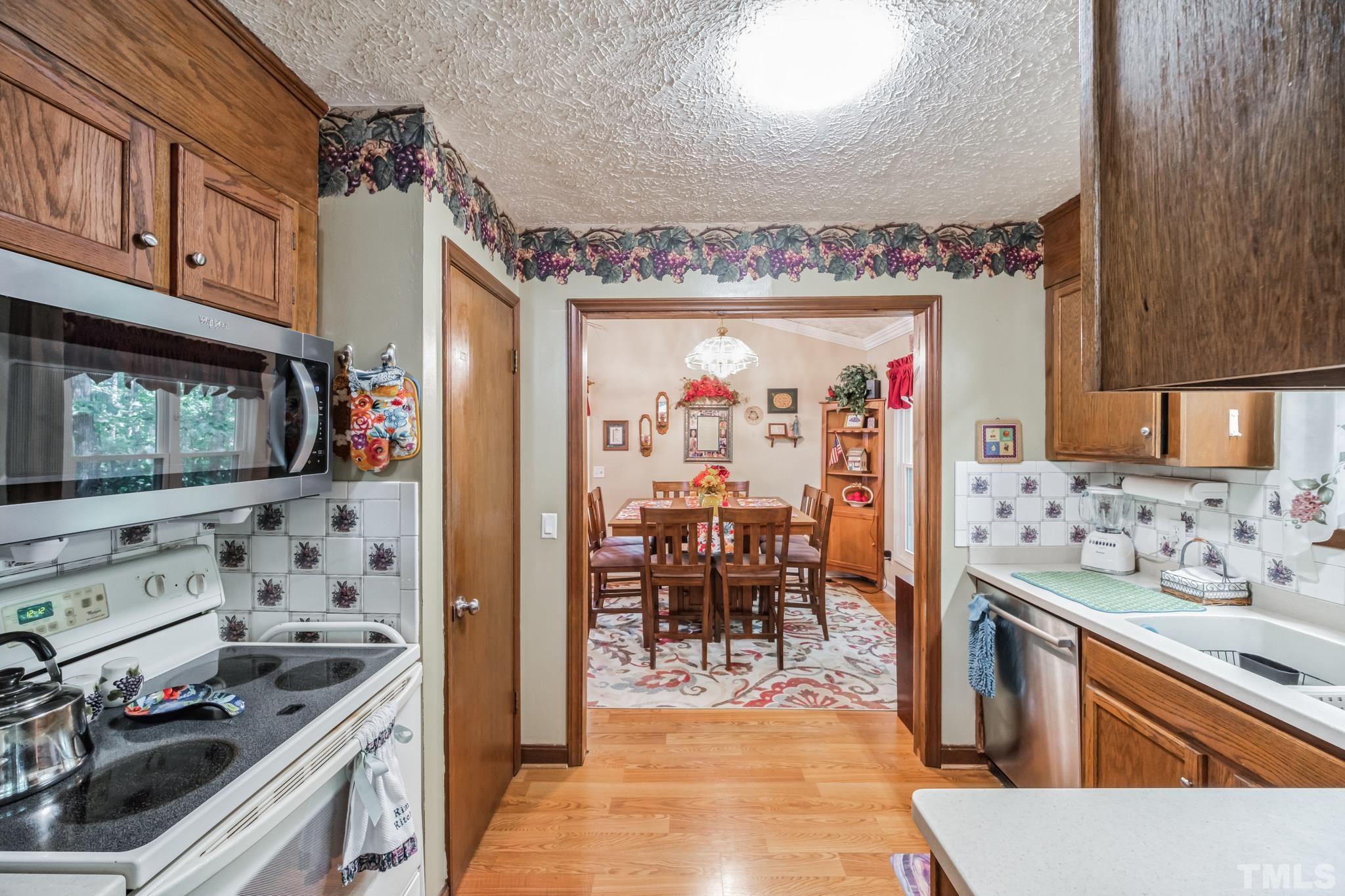 620 Long Avenue Roxboro, NC 27573 - Photo 20 of 39 a view of a kitchen with stainless steel appliances granite countertop a stove and a refrigerator