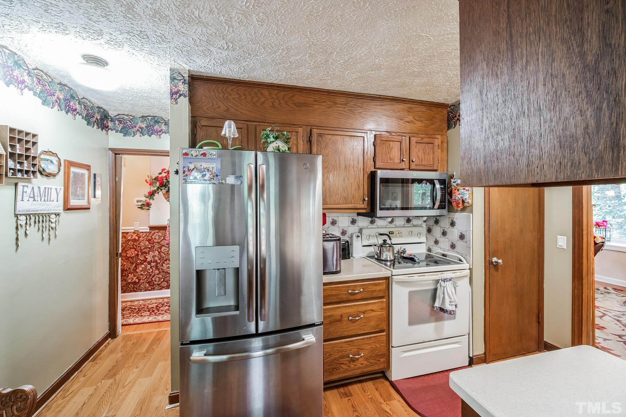620 Long Avenue Roxboro, NC 27573 - Photo 21 of 39 a kitchen with stainless steel appliances a refrigerator and cabinets