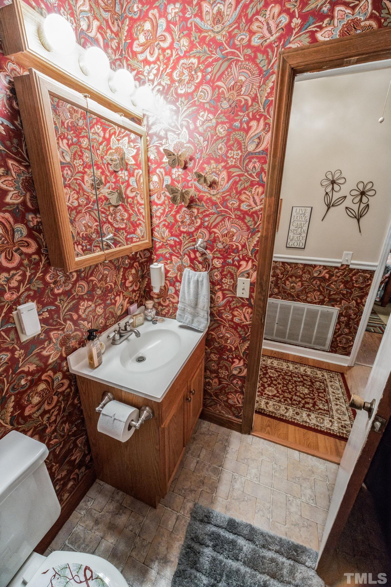 620 Long Avenue Roxboro, NC 27573 - Photo 6 of 39 a bathroom with a sink and mirror