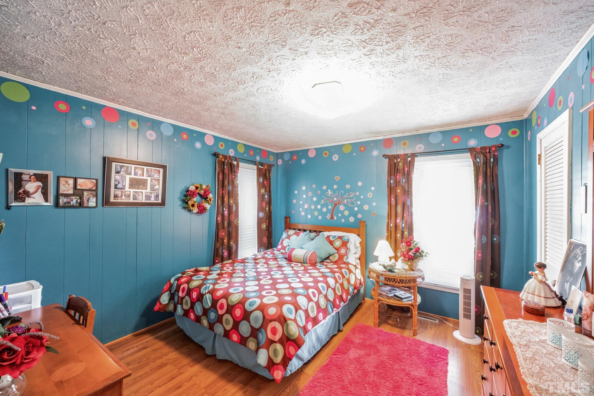 620 Long Avenue Roxboro, NC 27573 - Photo 8 of 39 a bedroom with a bed and a dresser next to a window