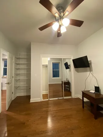 a room with wooden floor and furniture
