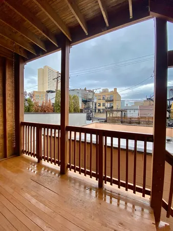 a view of a balcony with wooden floor