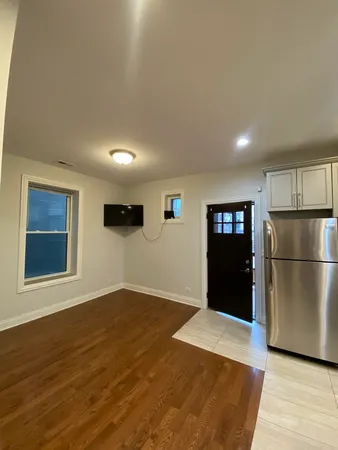 a view of a kitchen with wooden floor and electronic appliances
