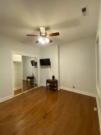 a view of a workspace with furniture and a ceiling fan