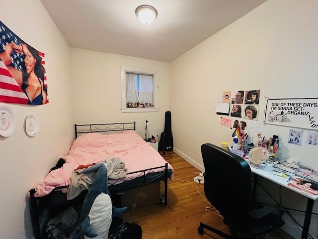 51 Calumet Street, Unit 1 Boston, MA 02120 - Photo 4 of 7 a bedroom with a bed and a table in it