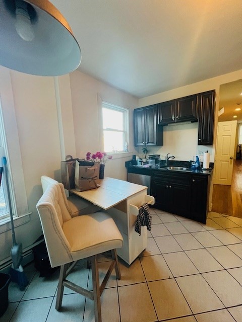 51 Calumet Street, Unit 1 Boston, MA 02120 - Photo 7 of 7 a living room with a table chairs and a refrigerator