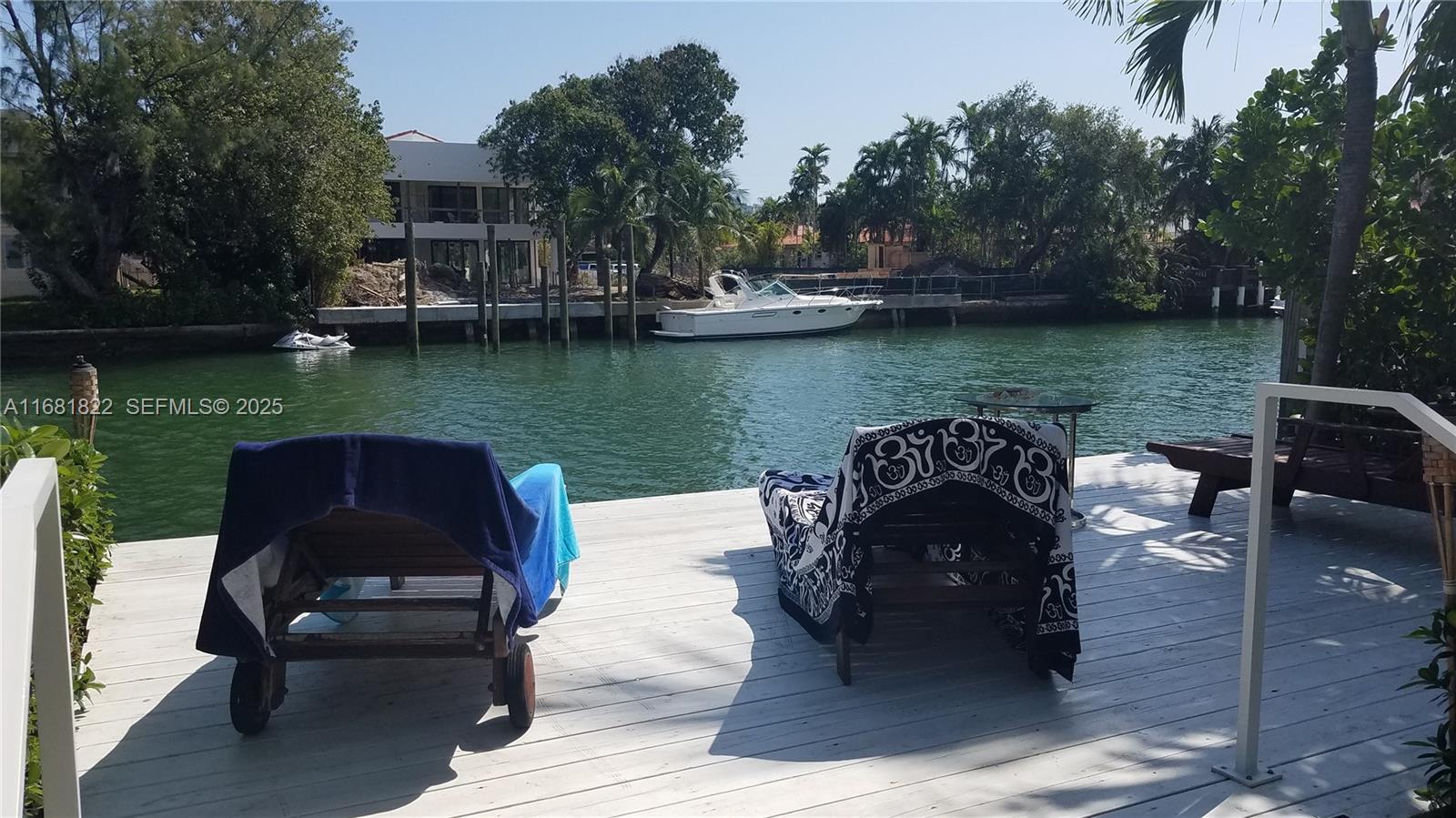 3921 Meridian Avenue Miami Beach, FL 33140 - Photo 12 of 29 a view of a lake with a patio table and chairs