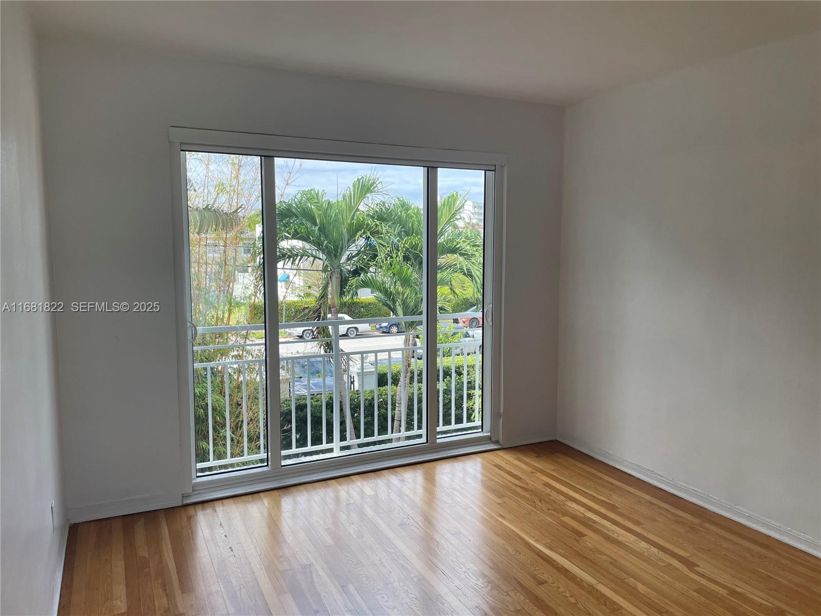 3921 Meridian Avenue Miami Beach, FL 33140 - Photo 21 of 29 a view of a room with wooden floor and doors
