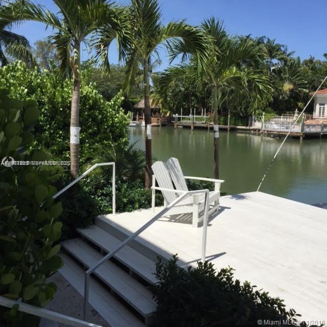 3921 Meridian Avenue Miami Beach, FL 33140 - Photo 8 of 29 a view of a lake with a bench next to a lake