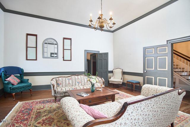 a view of a livingroom with furniture and hardwood floor