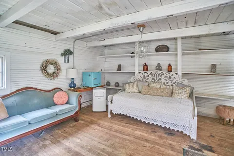 a view of a swimming pool with an outdoor seating and a yard