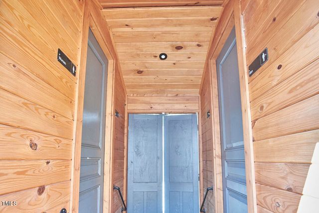 an aerial view of a house with a garden and trees