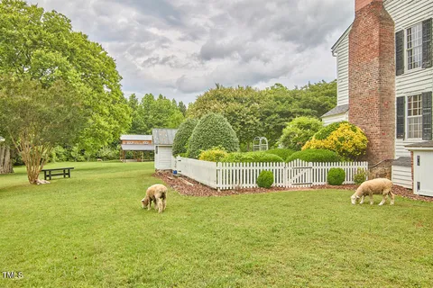 a view of living room with furniture and a fireplace