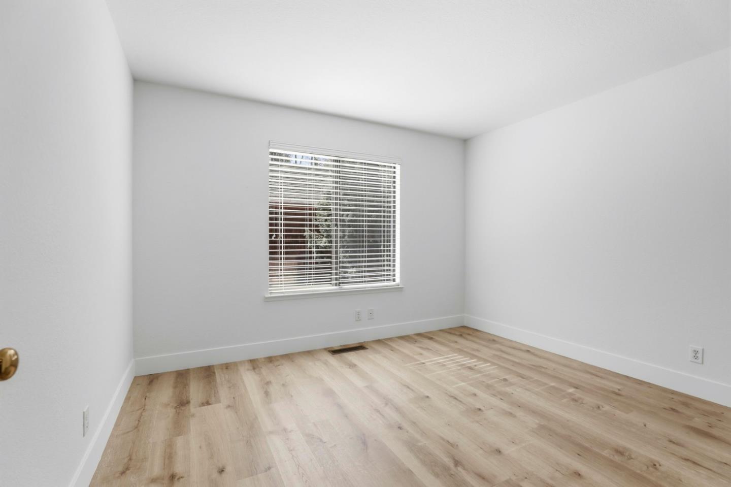 1555 Hecker Pass Road, Unit H102 Gilroy, CA 95020 - Photo 12 of 34 wooden floor in an empty room with a window