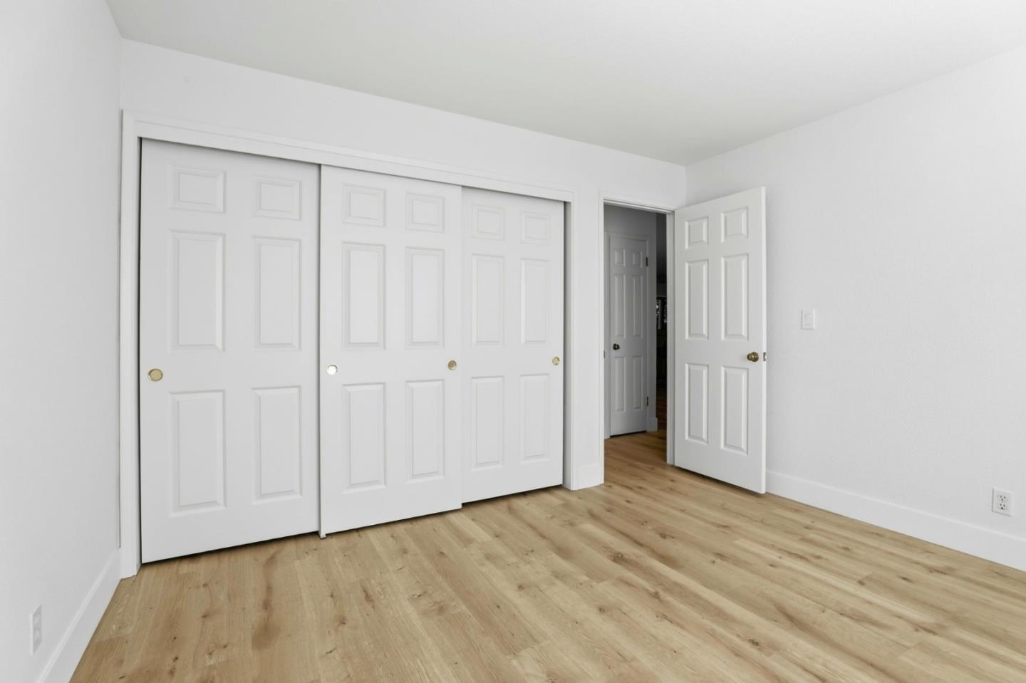 1555 Hecker Pass Road, Unit H102 Gilroy, CA 95020 - Photo 13 of 34 a view of an empty room with wooden floor