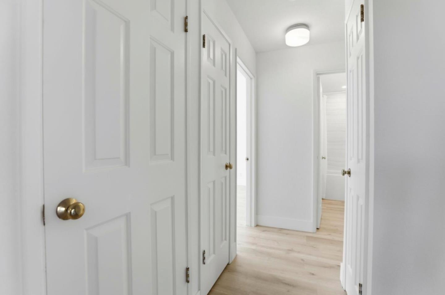1555 Hecker Pass Road, Unit H102 Gilroy, CA 95020 - Photo 17 of 34 a view of a hallway with wooden floor
