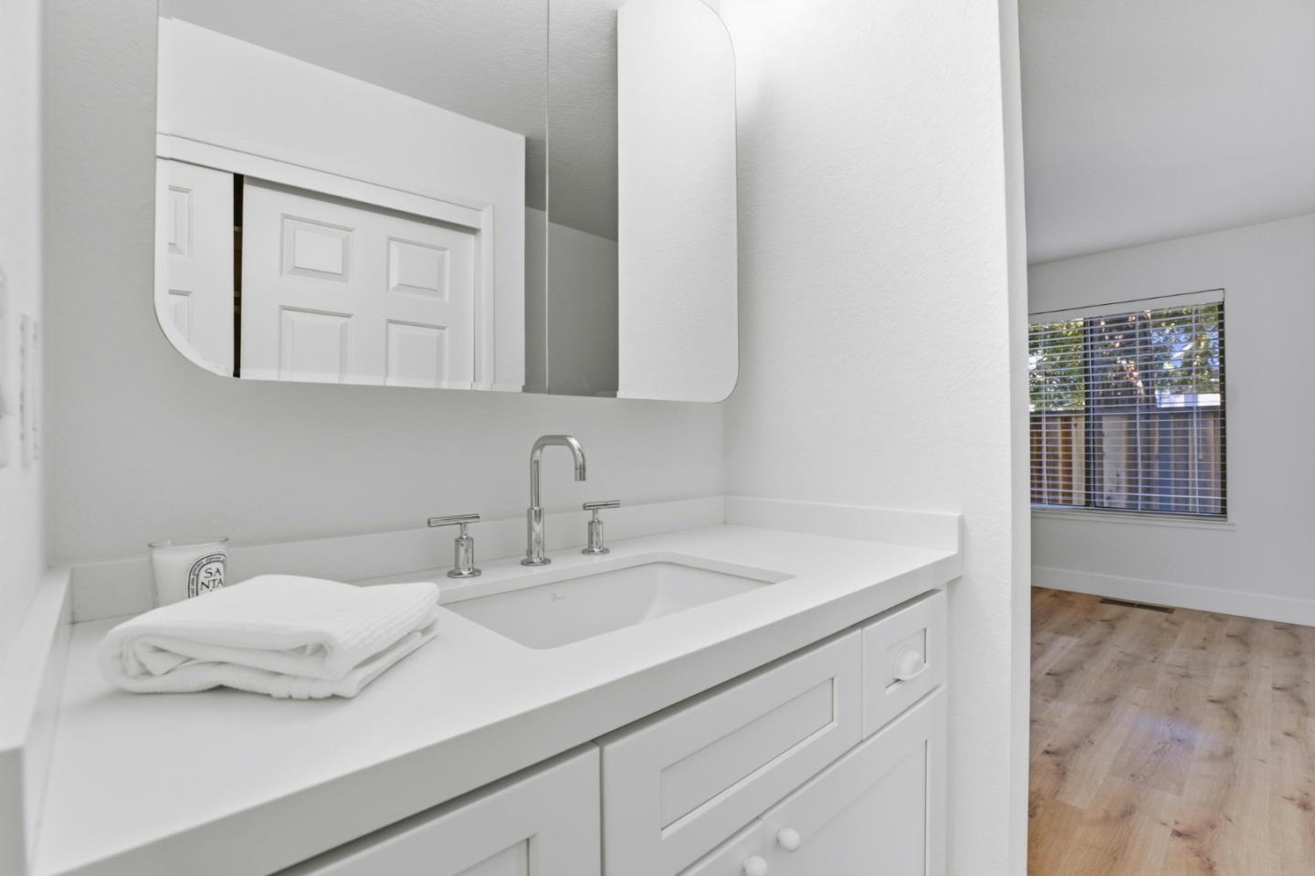 1555 Hecker Pass Road, Unit H102 Gilroy, CA 95020 - Photo 21 of 34 a bathroom with a sink and a mirror