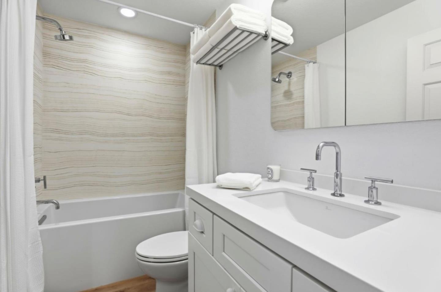 1555 Hecker Pass Road, Unit H102 Gilroy, CA 95020 - Photo 22 of 34 a bathroom with a sink a toilet and a bathtub